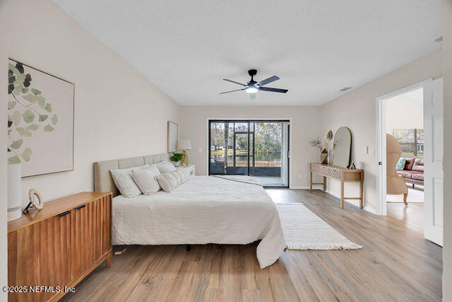 2191 Birch Bark Drive Jacksonville, FL 32246 - Photo 22 of 49 a bedroom with a large bed a chandelier and a window