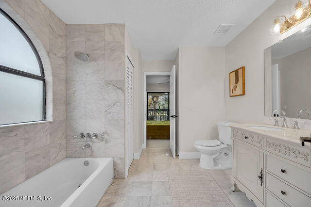 2191 Birch Bark Drive Jacksonville, FL 32246 - Photo 39 of 49 a bathroom with a toilet a sink a mirror a bathtub and shower