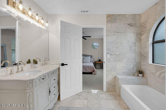 2191 Birch Bark Drive Jacksonville, FL 32246 - Photo 40 of 49 a spacious bathroom with a tub sink and mirror