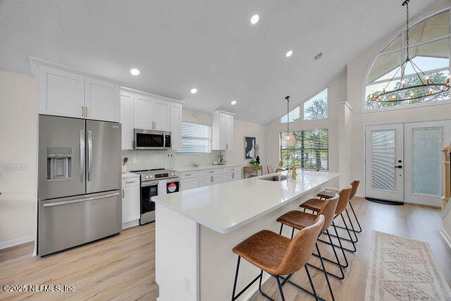 2191 Birch Bark Drive Jacksonville, FL 32246 - Photo 4 of 49 a kitchen with stainless steel appliances a refrigerator a stove a sink a dining table and chairs