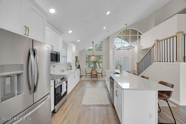 2191 Birch Bark Drive Jacksonville, FL 32246 - Photo 6 of 49 a view of a kitchen with fridge and wooden floor