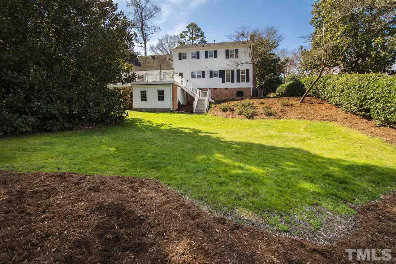 2000 Lewis Circle Raleigh, NC 27608 - Photo 29 of 30 a view of a house with a big yard and large trees
