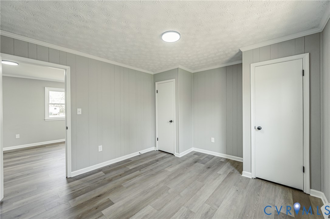 15412 Exter Mill Road Chesterfield, VA 23838 - Photo 54 of 60 Empty room featuring ornamental molding, light woo