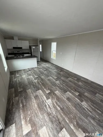 a view of kitchen and empty room