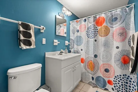 a bathroom with a sink and mirror with painted walls