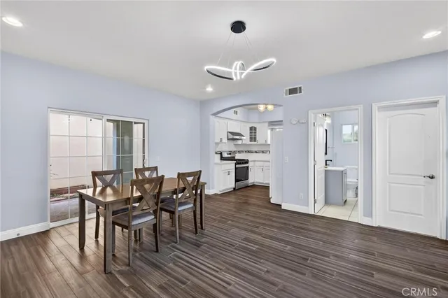 a view of a dining room with furniture and wooden floor
