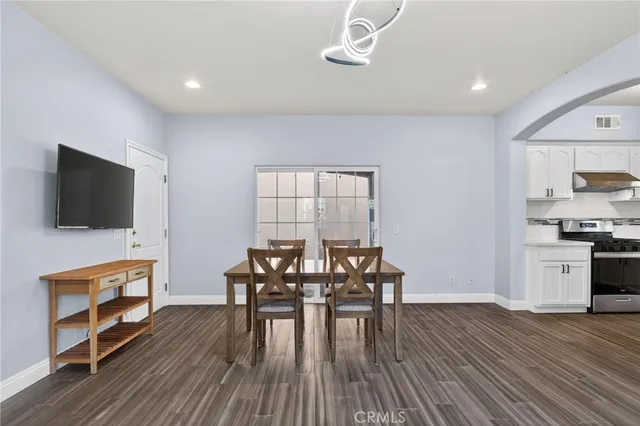 a view of a dining room with furniture and wooden floor