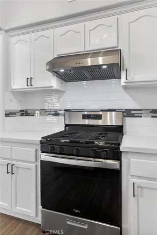 a stove top oven sitting inside of a kitchen