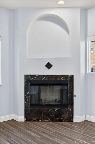 a living room with a fireplace and a wooden floor