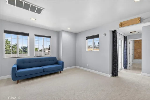 a living room with a couch and a window