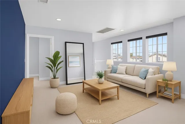 a living room with furniture and a potted plant