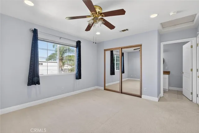 a bathroom with a granite countertop sink a toilet and shower