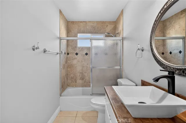 a view of a balcony with wooden floor and fence