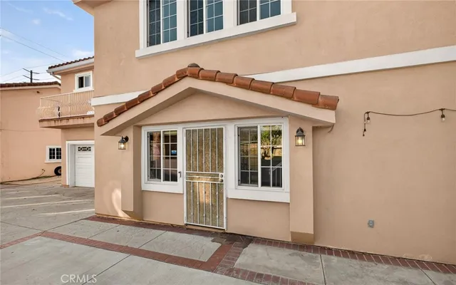 a view of a house with a garage and balcony