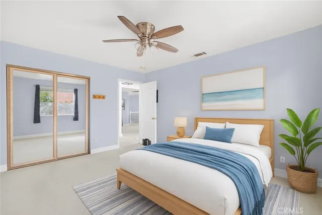 a bedroom with a large bed and a chandelier