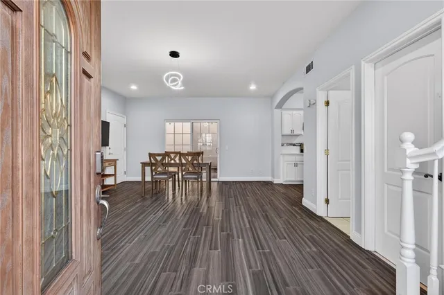 a view of a livingroom with furniture and hardwood floor