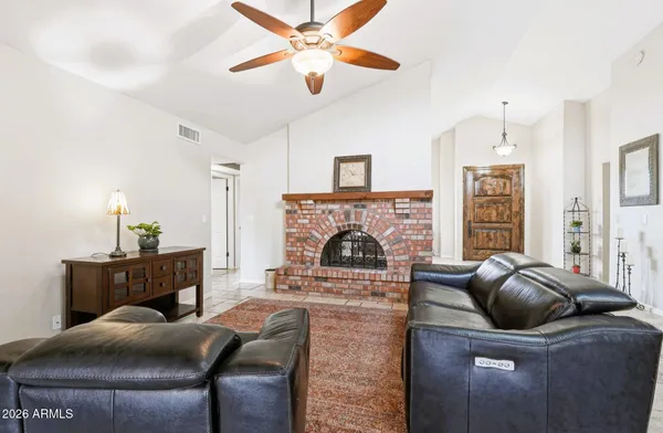 a living room with furniture and a fireplace