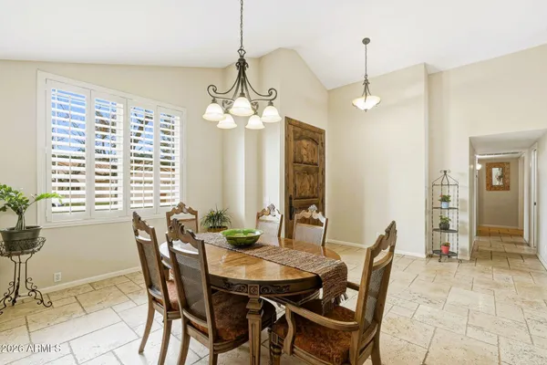 a view of a dining room with furniture and a chandelier