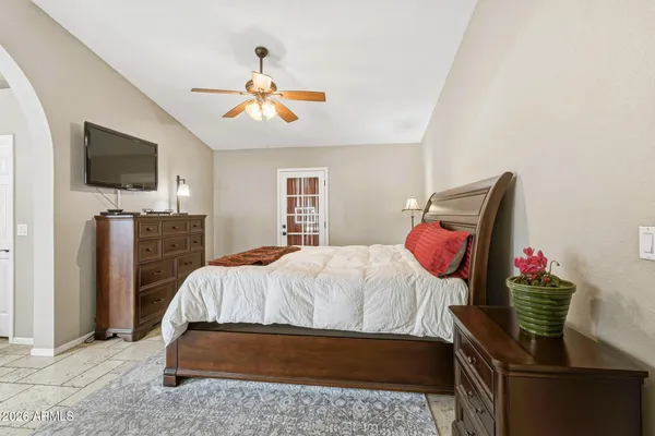 a bedroom with a bed and flat screen tv