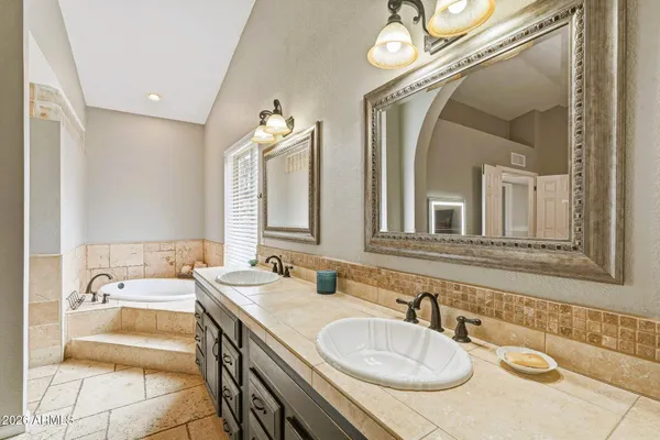a bathroom with a granite countertop sink a mirror and a