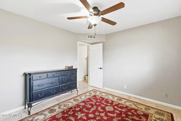 a room with a dresser and a chandelier
