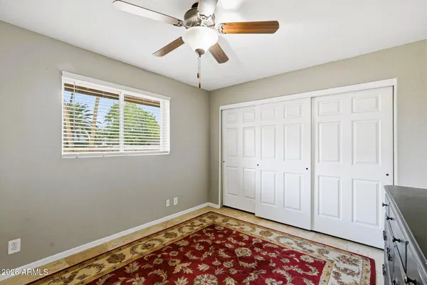 a view of an empty room with a window and closet