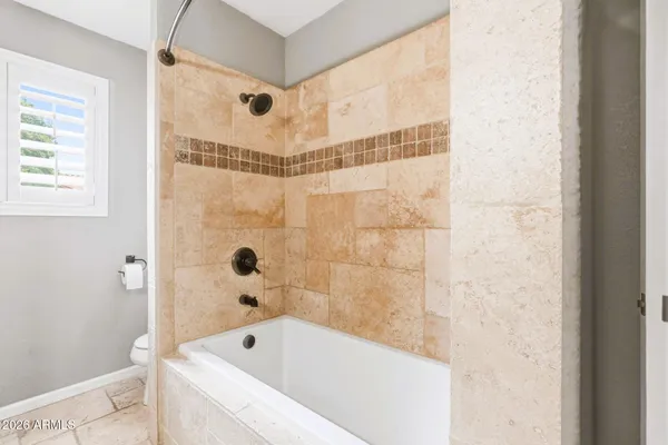 a bathroom with a bathtub and shower