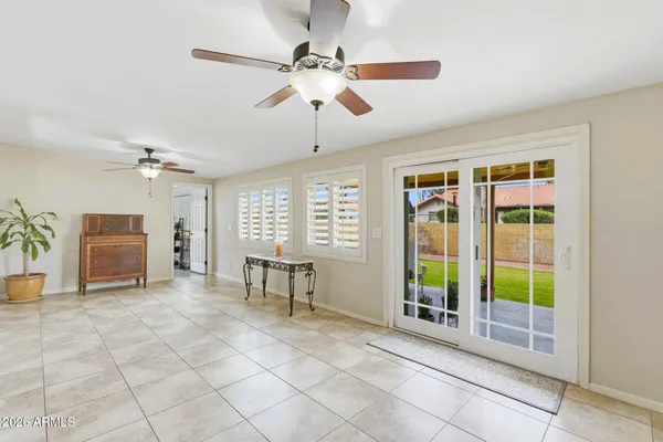 a view of a livingroom with furniture wooden floor and a ceiling fan