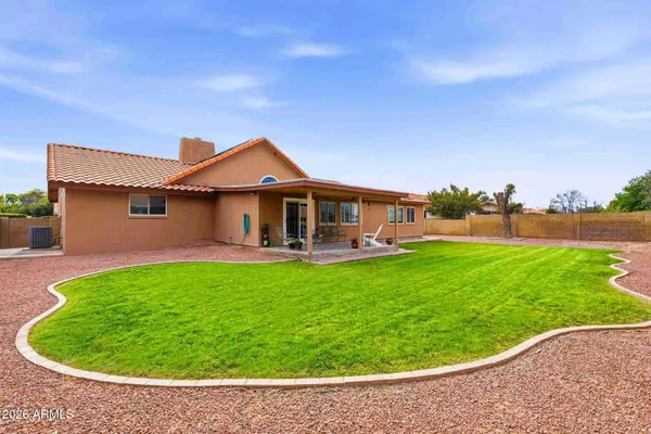 a view of a house with a backyard