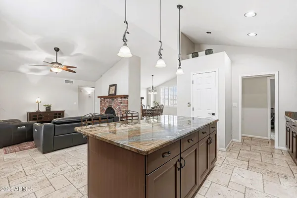 a kitchen with stainless steel appliances granite countertop a sink a stove and a refrigerator