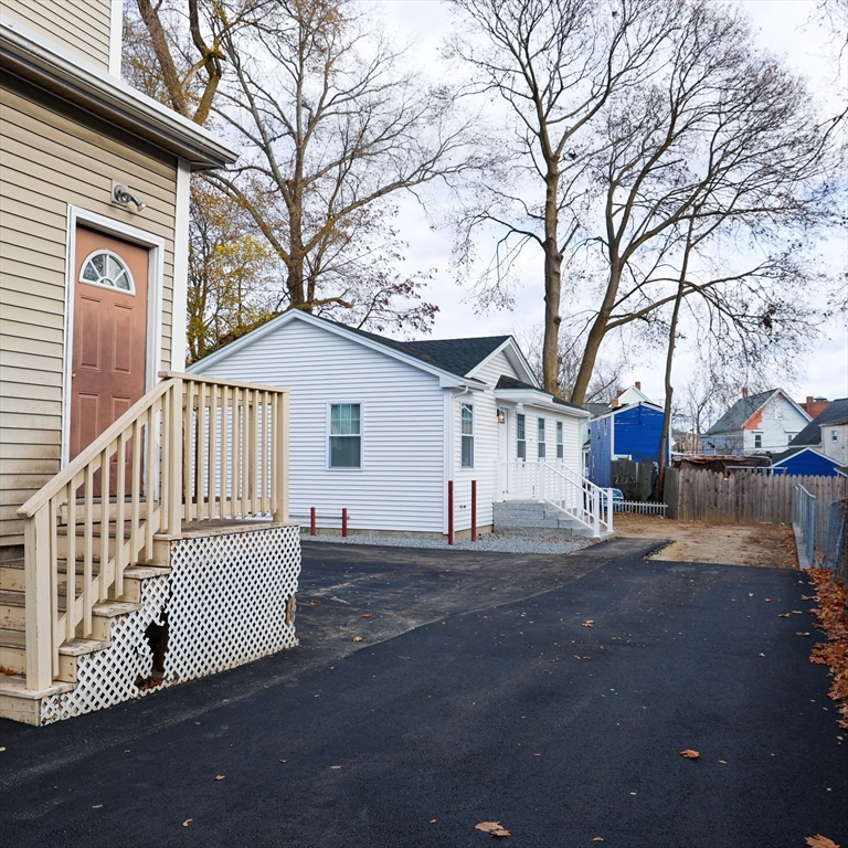 598 School Street, Unit REAR ADU Lowell, MA 01851 - Photo 11 of 42 a view of a house with a yard
