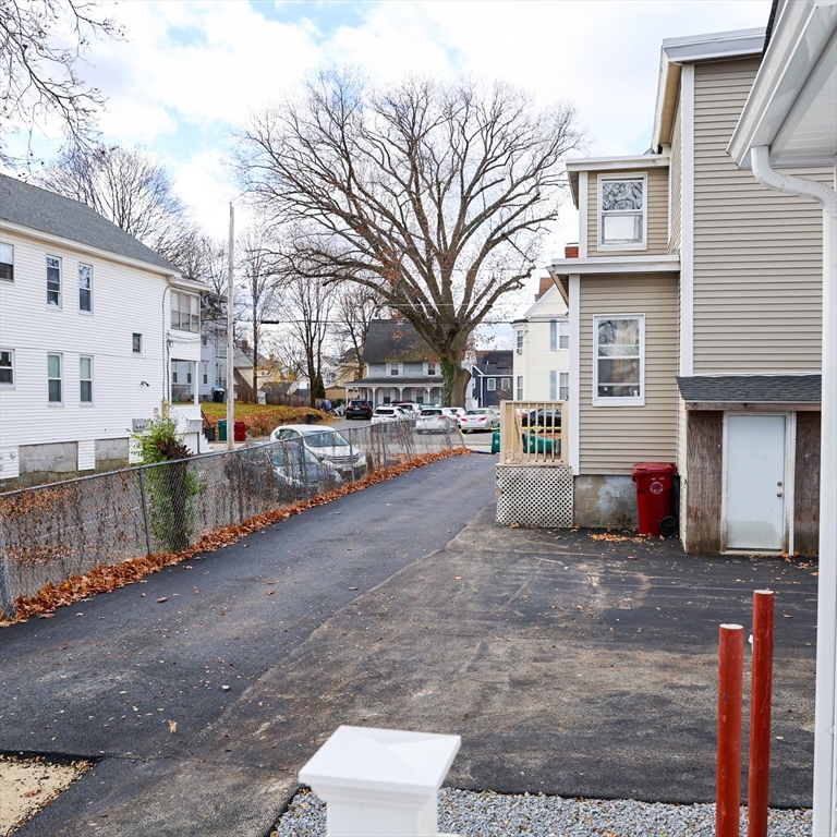 598 School Street, Unit REAR ADU Lowell, MA 01851 - Photo 12 of 42 a view of road with card parked on roof and parked
