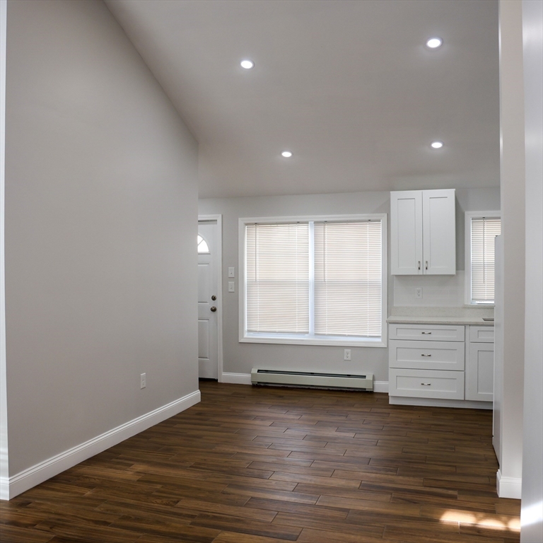 598 School Street, Unit REAR ADU Lowell, MA 01851 - Photo 16 of 42 a view of room and wooden floor