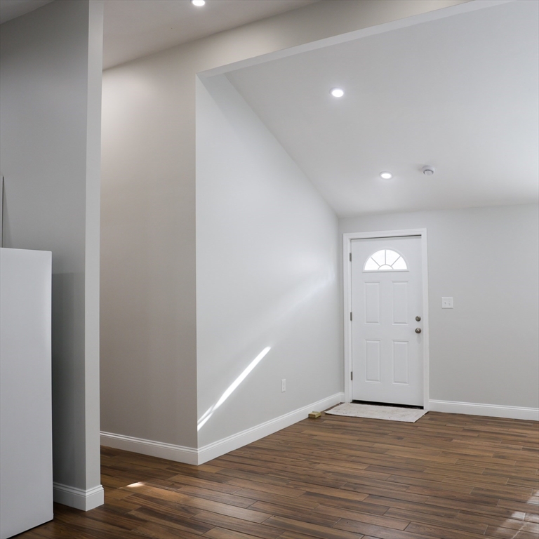 598 School Street, Unit REAR ADU Lowell, MA 01851 - Photo 19 of 42 a view of an empty room with wooden floor and closet