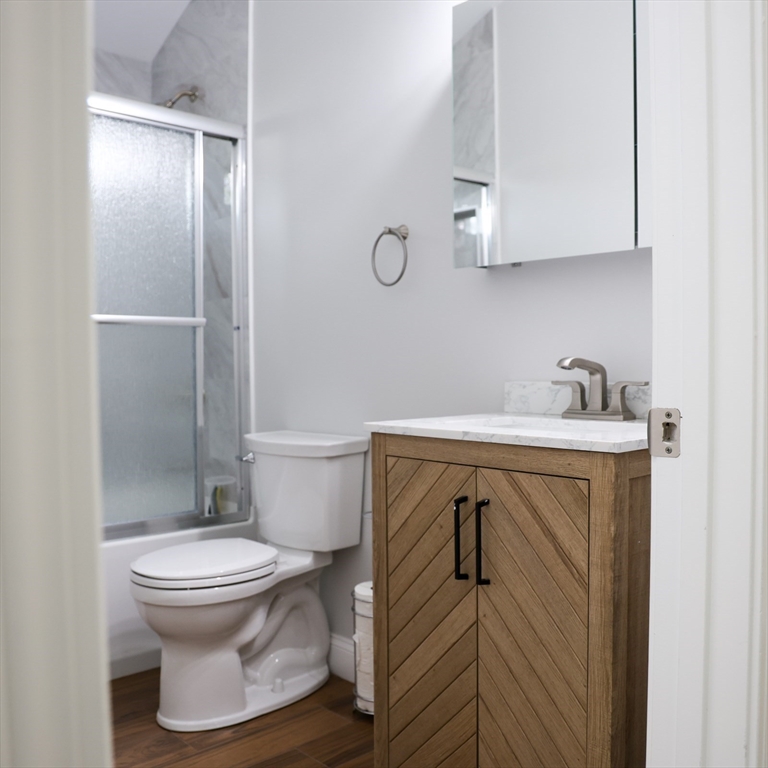 598 School Street, Unit REAR ADU Lowell, MA 01851 - Photo 29 of 42 a bathroom with a sink toilet and shower