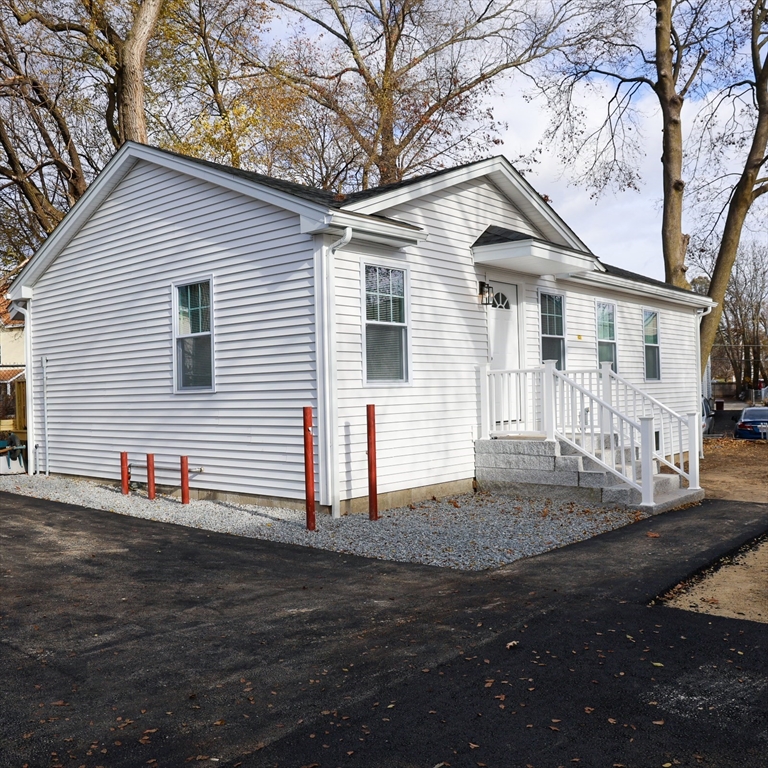 598 School Street, Unit REAR ADU Lowell, MA 01851 - Photo 3 of 42 a view of a house with a yard