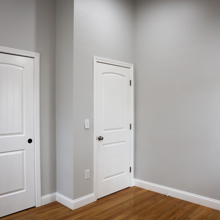 598 School Street, Unit REAR ADU Lowell, MA 01851 - Photo 33 of 42 a view of empty room with wooden floor