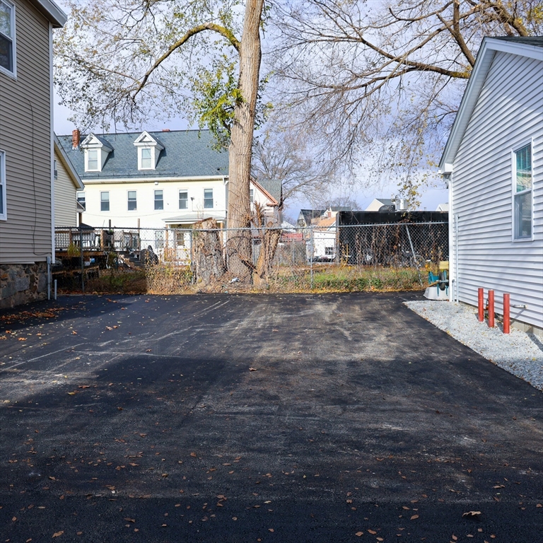 598 School Street, Unit REAR ADU Lowell, MA 01851 - Photo 8 of 42 a view of a house with a yard