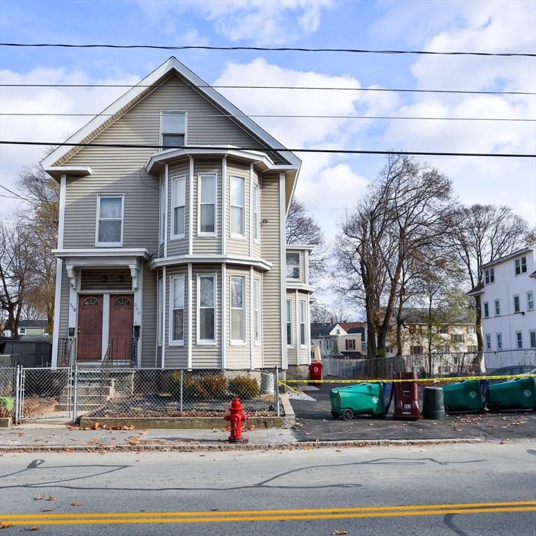 598 School Street, Unit REAR ADU Lowell, MA 01851 - Photo 9 of 42 a front view of a house with a yard