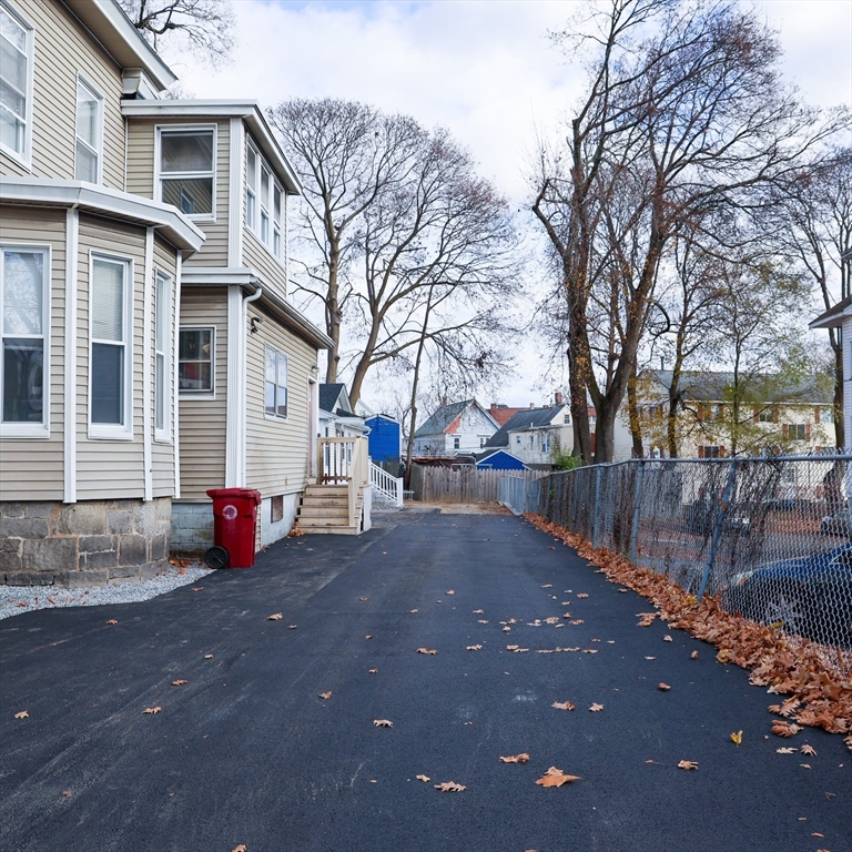 598 School Street, Unit REAR ADU Lowell, MA 01851 - Photo 10 of 42 a view of a house with a yard