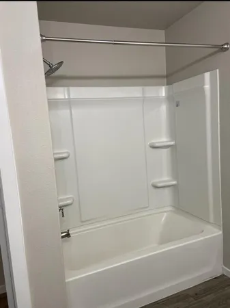 a bathroom with a shower and a bath tub