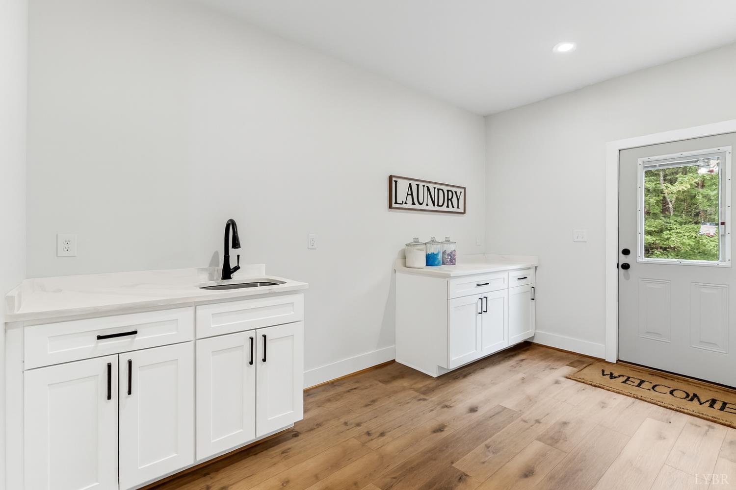 594 Community Road Dillwyn, VA 23936 - Photo 11 of 49 a view of a kitchen with wooden floor and electronic appliances