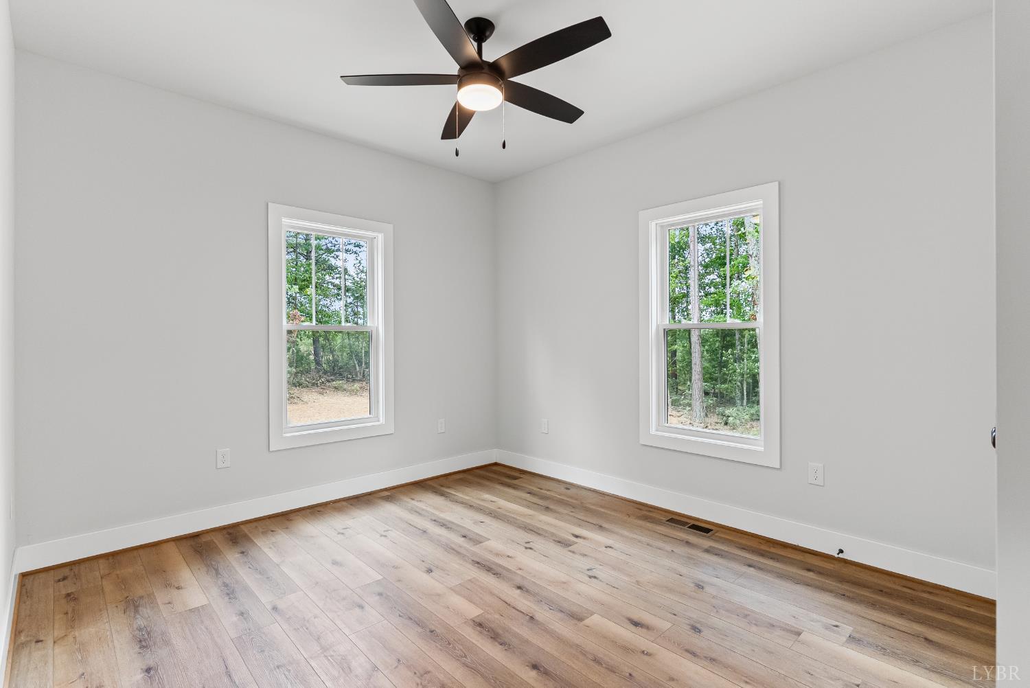 594 Community Road Dillwyn, VA 23936 - Photo 26 of 49 an empty room with wooden floor and windows