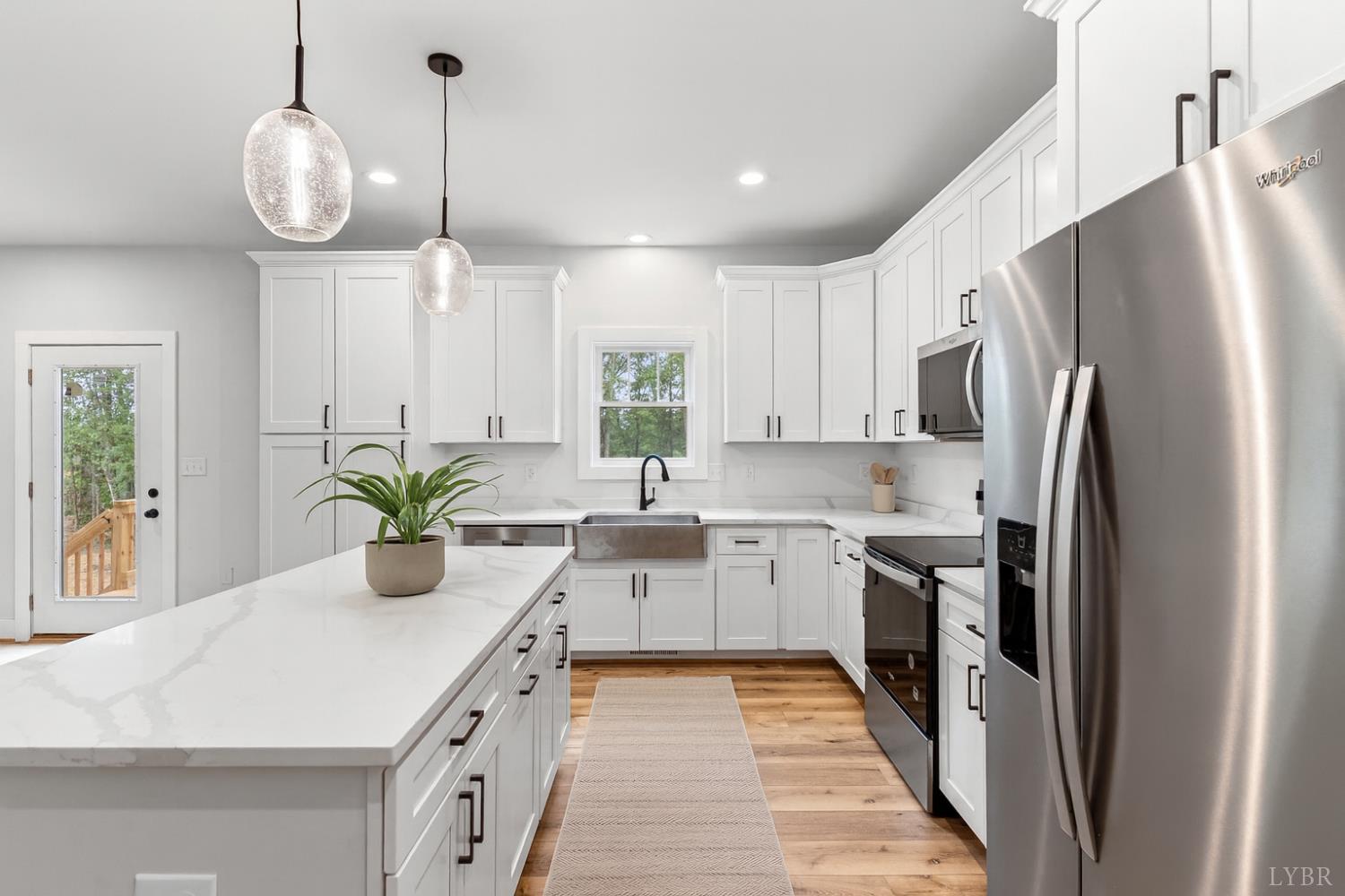 594 Community Road Dillwyn, VA 23936 - Photo 6 of 49 a kitchen with sink a refrigerator and chairs