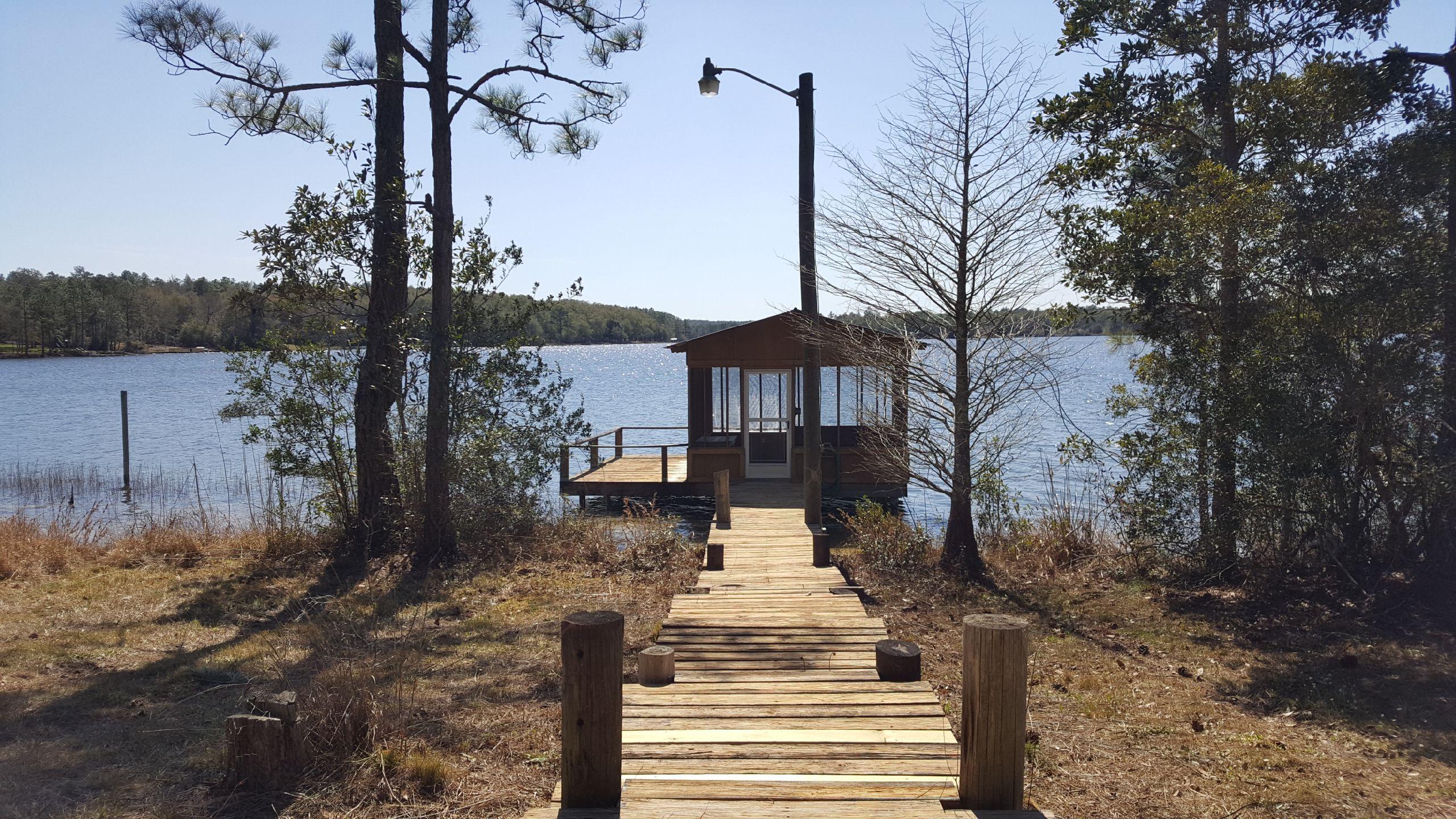 Lot 25 Spring Lake Road DeFuniak Springs, FL 32433 - Photo 1 of 8 a front view of a house with a yard and large tree