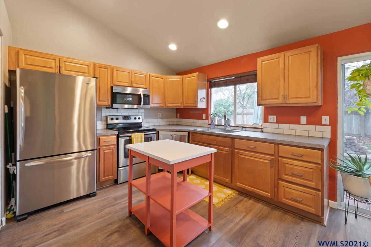 1206 Briar Road Independence, OR 97351 - Photo 16 of 38 a kitchen with stainless steel appliances granite countertop a refrigerator a sink dishwasher a stove and a refrigerator with wooden floor