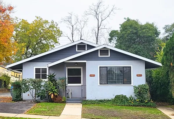 a front view of house with yard and green space