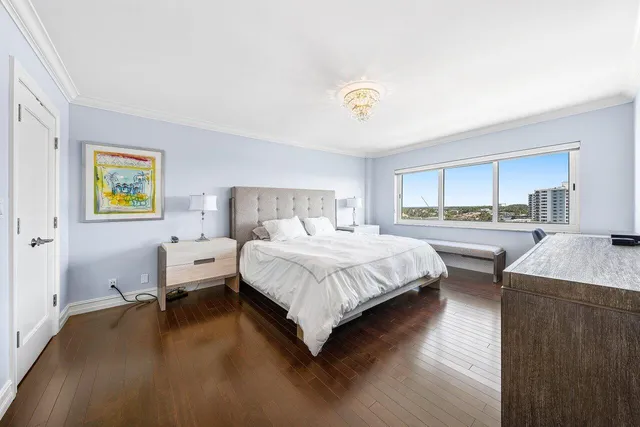 a bedroom with a bed and painting on the wall