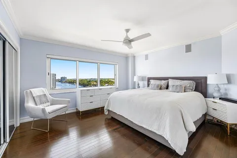 a bedroom with a bed and a large window