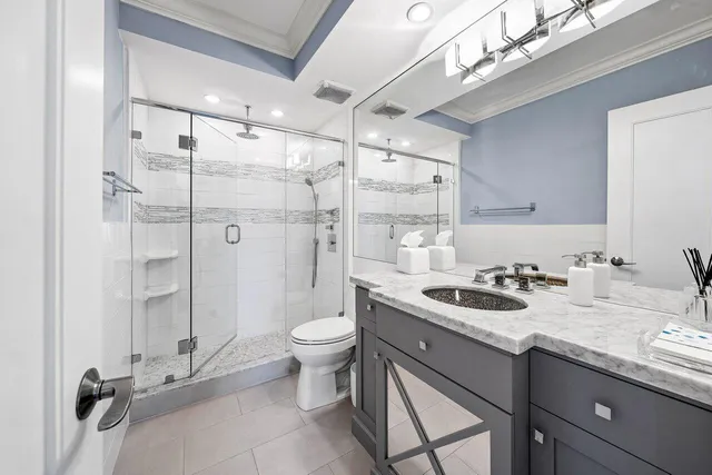 a bathroom with a sink toilet and shower